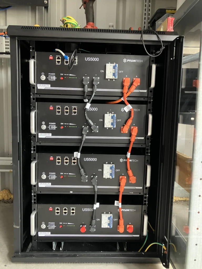 5kW Victron MultiPlus inverter/charger and SmartSolar MPPT 150/100 charge controller wall-mounted in the equipment enclosure