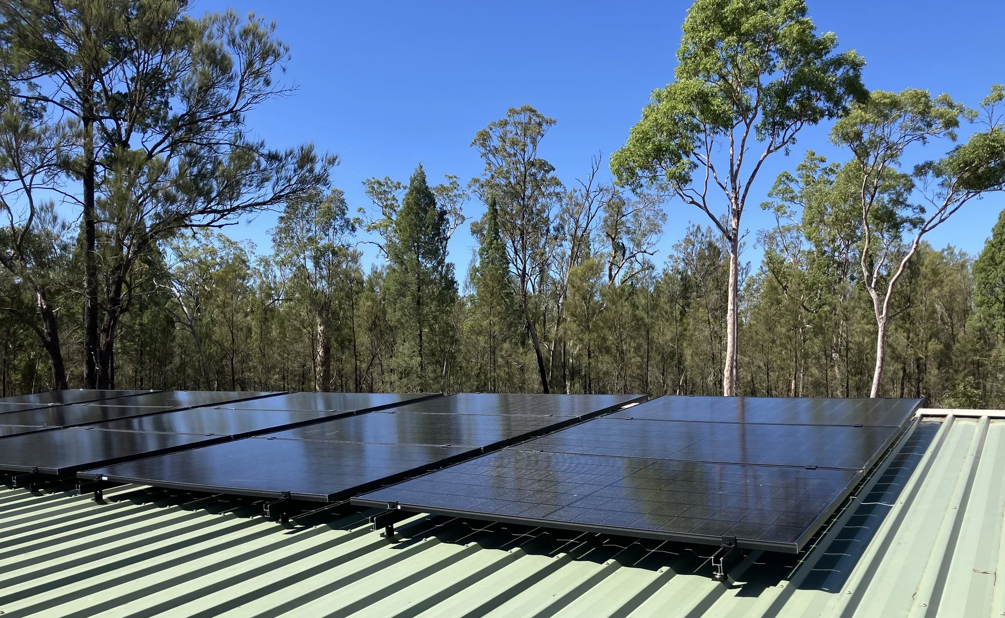 6.6kW Suntech solar array installed on a green Colorbond roof at a rural Millmerran Woods property in regional Queensland