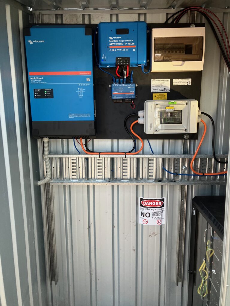 Victron inverter and solar charge controller installed in battery shed